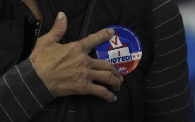 Local voters wade through flood waters to vote in highly-contested races